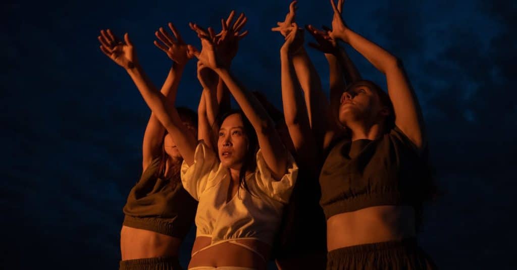 a-low-angle-shot-of-women-dancing-while-raising-their-hands-1