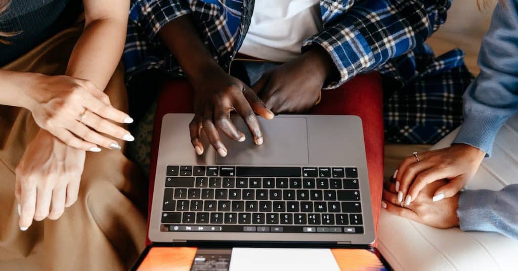 diverse-women-chatting-online-on-laptop