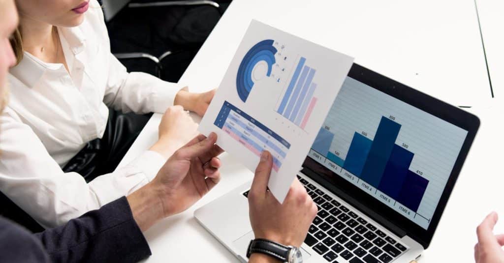 KWE Stock: Tech Defense Innovator Shaping Government Contracts 4 business-professionals-discussing-data-charts-and-graphs-in-a-modern-office-setting-2