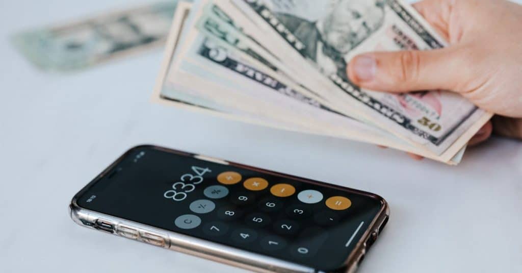 Cash App Borrow: Get Quick Loans in Minutes Instantly 1 calculator-application-on-mobile-phone-screen-on-white-surface-near-crop-anonymous-person-holding-pi