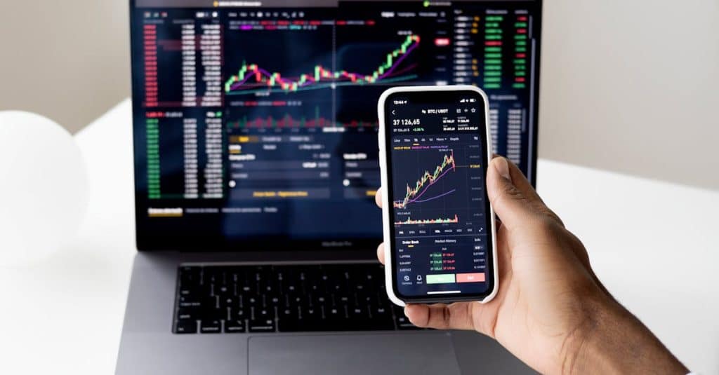 Alephium Price: Unveiling the Crypto Gem's Market Potential 8 person-checking-stock-market-graphs-on-laptop-and-smartphone-focusing-on-financial-data